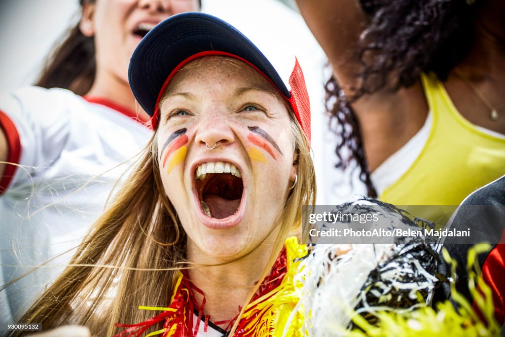 German football fan cheering at match