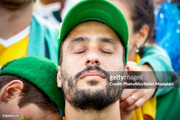 football fan with head back and eyes closed in disappointment - yellow hat stock pictures, royalty-free photos & images
