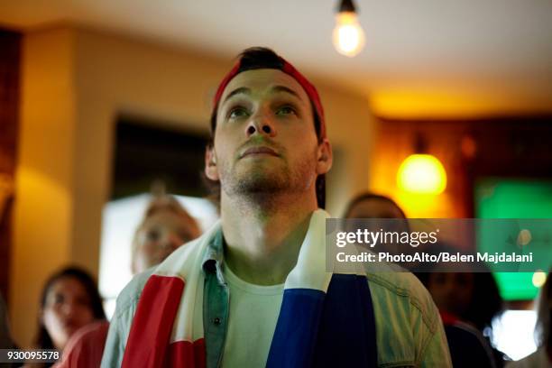 french football fan watching match in bar - soccer fan stockfoto's en -beelden