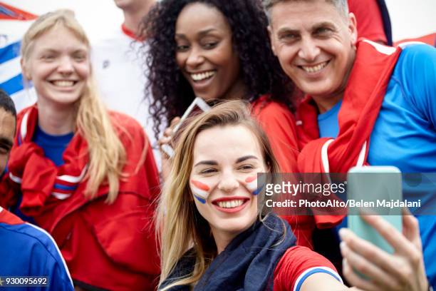 french football fan taking a selfie at football match - red and white people stock pictures, royalty-free photos & images