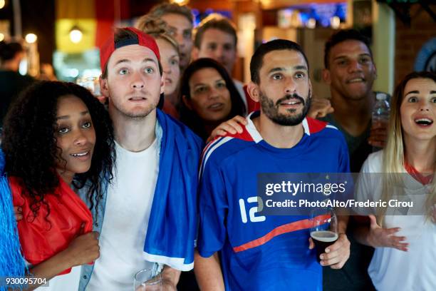 french football fans watching soccer match on television at pub - football for hope stock-fotos und bilder