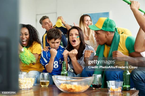 brazilian soccer fans watching televised match together - fifa world cup pre tournament stock pictures, royalty-free photos & images