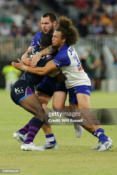 Suliasi Vunivalu of the Storm is tackled by Raymond Faitala-Mariner of the Bulldogs during the round one NRL match between the Canterbury Bulldogs...