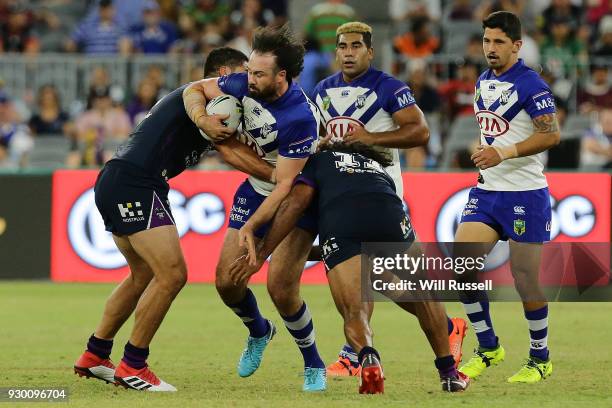 Aaron Woods of the Bulldogs is tackled during the round one NRL match between the Canterbury Bulldogs and the Melbourne Storm at Optus Stadium on...