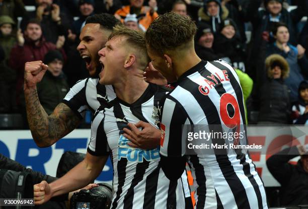 Matt Ritchie of Newcastle United celebrates scoring his side's third goal with Jamaal Lascelles and Dwight Gayle during the Premier League match...