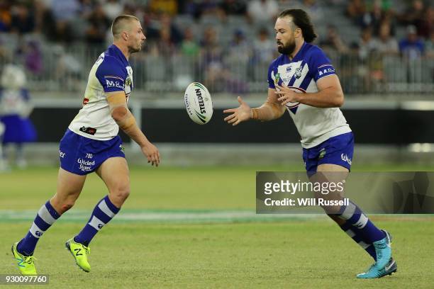 Kieran Foran of the Bulldogs passes the ball to Aaron Woods of the Bulldogs during the round one NRL match between the Canterbury Bulldogs and the...