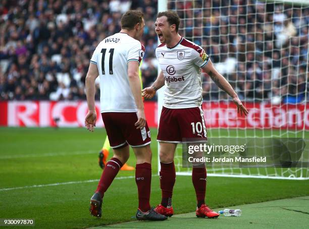 Ashley Barnes of Burnley celebrates with teammate Chris Wood after scoring his sides first goal during the Premier League match between West Ham...