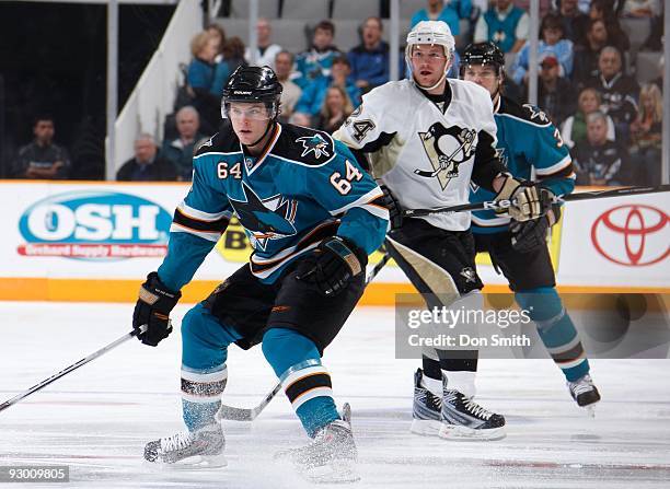 Matt Cooke of the Pittsburgh Penguins watches the play up ice between Jamie McGinn and Douglas Murray of the San Jose Sharks during an NHL game on...