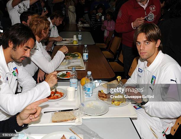 Mattia Cassani and Daniele Galloppa dine during the Italy National soccer team visit to earthquake striken areas in L'Aquila, Coppito on November 12,...