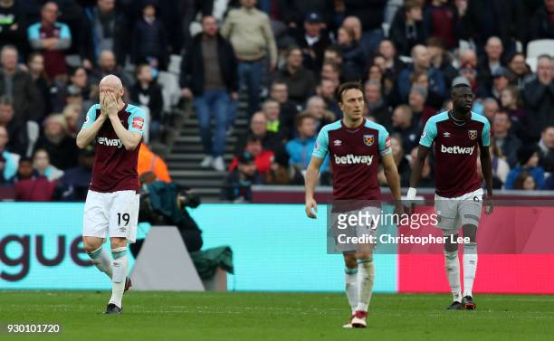 West Ham United players look dejected during the Premier League match between West Ham United and Burnley at London Stadium on March 10, 2018 in...