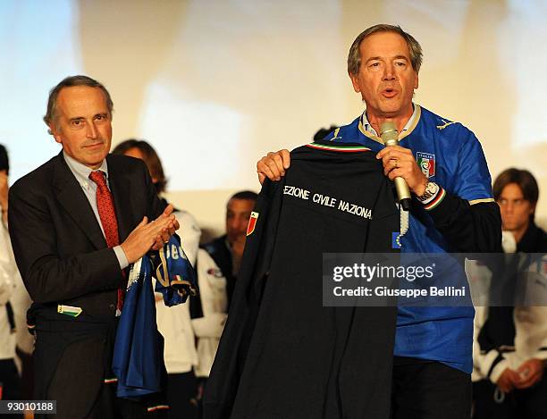 Giancarlo Abete the President of FIGC and Guido Bertolaso speak during the Italy national soccer team visit to earthquake striken areas in L'Aquila,...