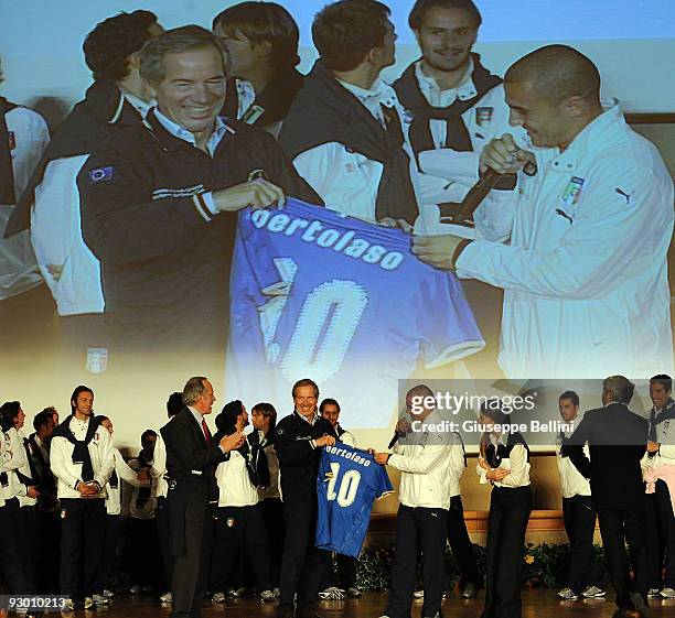 Guido Bertolaso and Fabio Cannavaro speak during the Italy national soccer team visit to earthquake striken areas in L'Aquila, Coppito on November...