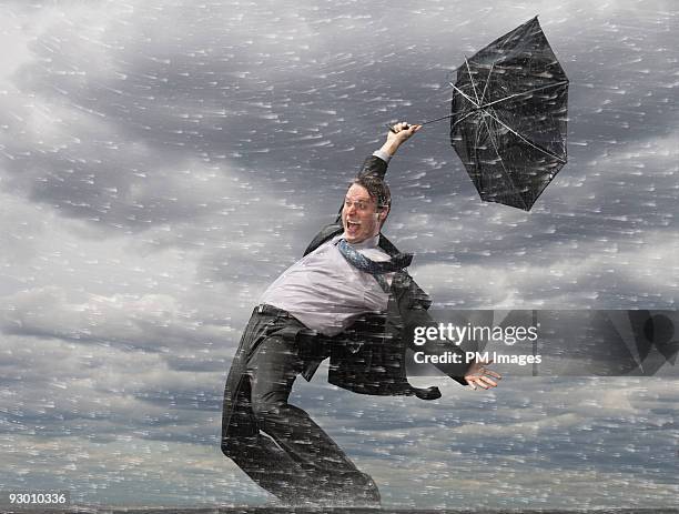 businessman in hurricane  - hombre mojado fotografías e imágenes de stock