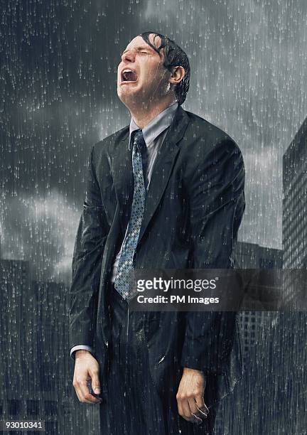 businessman crying in rain - doorweekt stockfoto's en -beelden