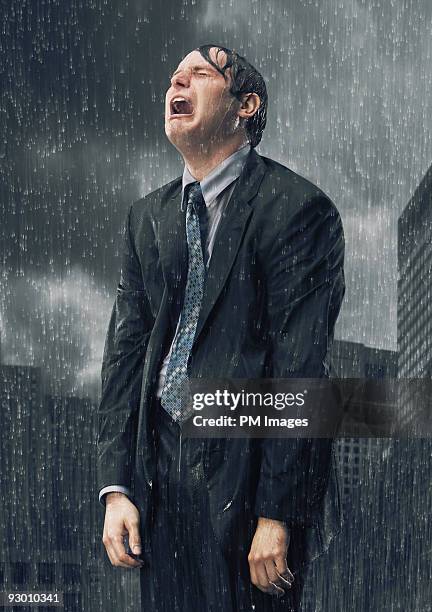 businessman crying in rain - drenched stock pictures, royalty-free photos & images