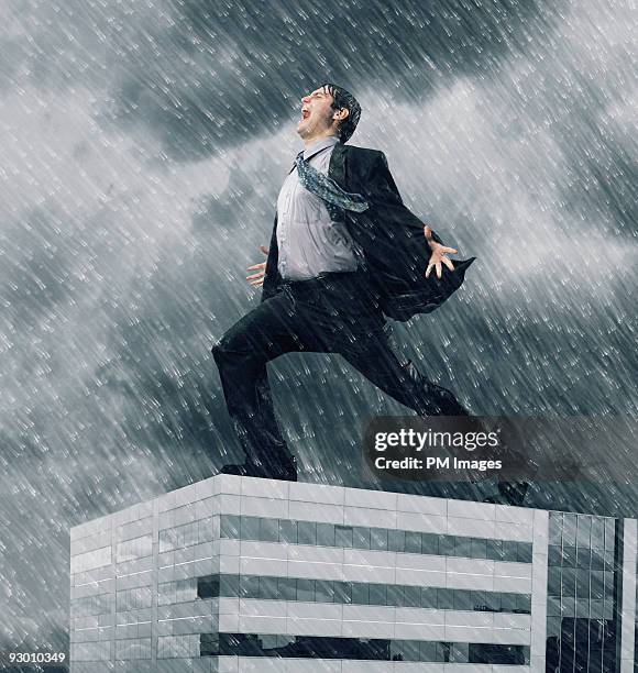 businessman yelling on the roof - durchnässt stock-fotos und bilder