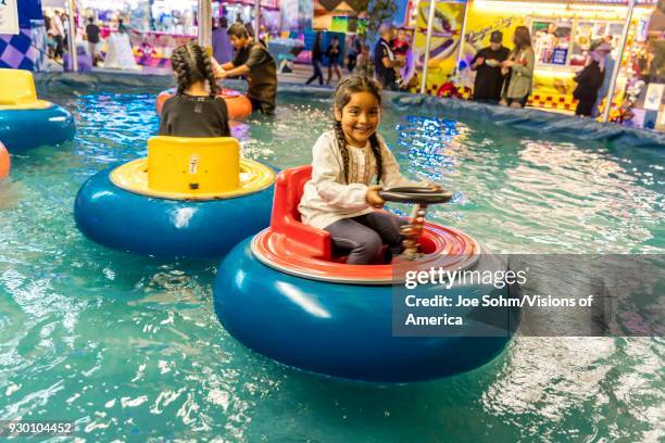 Hispanic girl and water ride at the Ventura County Fair.