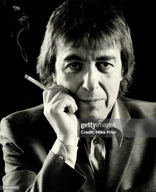 Former Rolling Stones bass player Bill Wyman poses for a studio portrait holding a cigarette c 2001 in London.