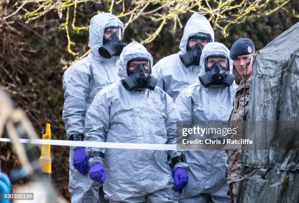 Military personnel wearing protective suits prepare to remove two ambulances from Salisbury ambulance station as they continue investigations into...