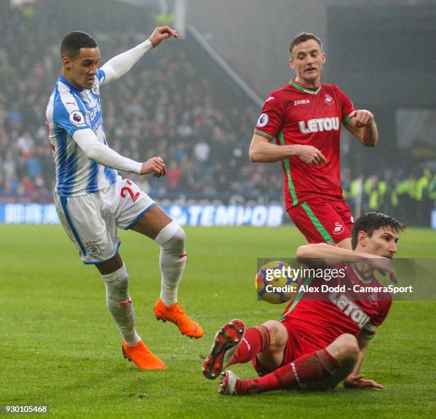 Huddersfield Town's Thomas Ince sees his shot blocked by Swansea City's Federico Fernandez during the Premier League match between Huddersfield Town...