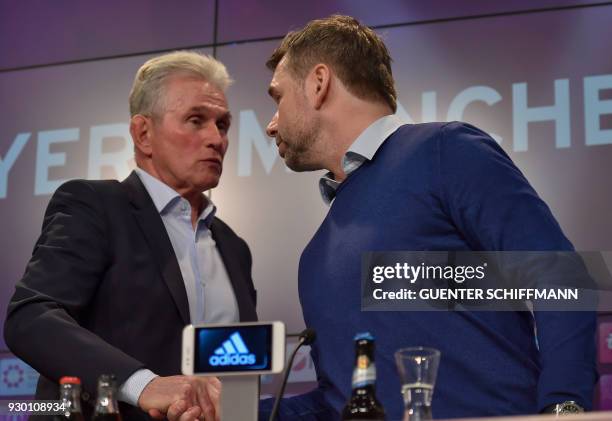 Bayern Munich's German head coach Jupp Heynckes and Hamburg's German coach Bernd Hollerbach shake hands during a press conference after the German...