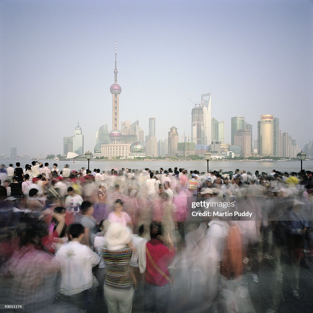 Crowds of people in front of Pudong Skyline.