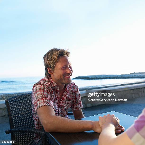 male couple enjoy time cafe - gary bond stock pictures, royalty-free photos & images