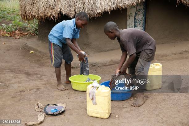 Ugandan children washing laundry.