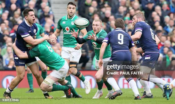 Ireland's wing Keith Earls vies with Scotland's scrum-half Greig Laidlaw during the Six Nations international rugby union match between Ireland and...