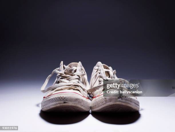 white classic canvas sneakers with laces open. - untied shoelace stock pictures, royalty-free photos & images