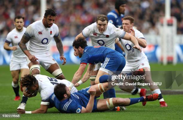 Nathan Hughes of England is tackled during the NatWest Six Nations match between France and England at Stade de France on March 10, 2018 in Paris,...