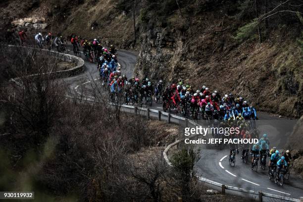The pack rides during the seventh stage of the Paris - Nice cycling race between Nice and Valdeblore La Colmiane on March 10, 2018. / AFP PHOTO /...
