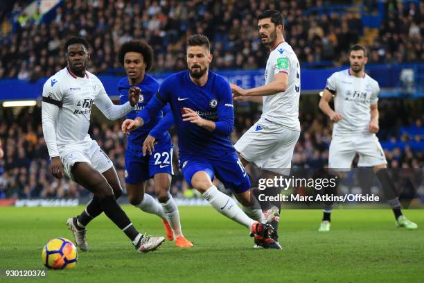 Olivier Giroud of Chelsea in action with Jeffrey Schlupp and James Tomkins of Crystal Palace during the Premier League match between Chelsea and...