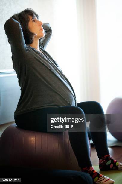 Antenatal yoga class, Haute-Savoie, France, Women practice yoga poses that are traditional and adapted to create serene pregnancy.