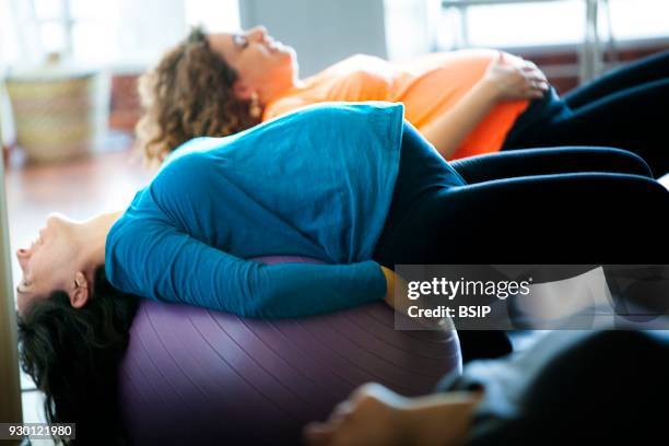 Antenatal yoga class, Haute-Savoie, France, Women practice yoga poses that are traditional and adapted to create serene pregnancy.