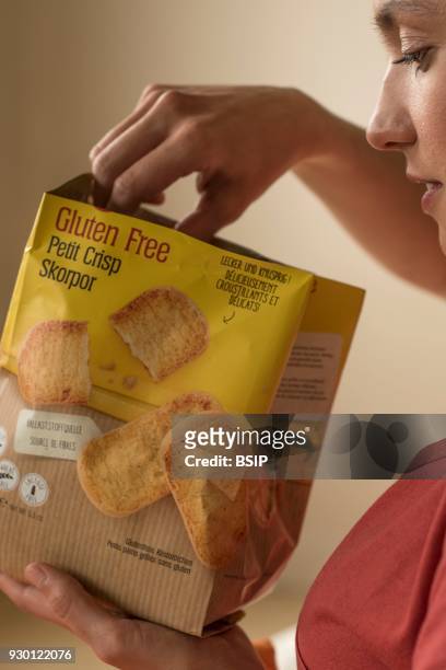 Woman eating gluten-free crisp bread.