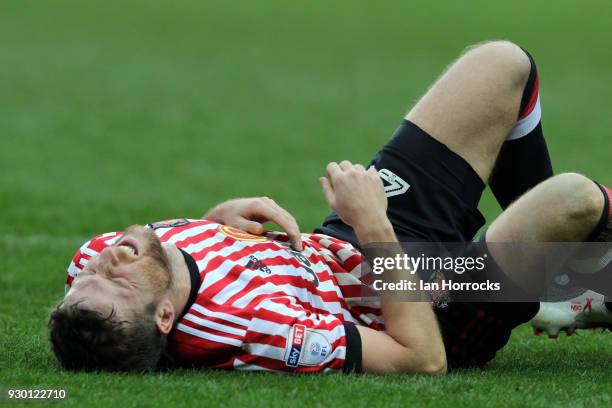 Adam Matthews of Sunderland lies injured during the Sky Bet Championship match between Queens Park Rangers and Sunderland at Loftus Road on March 10,...