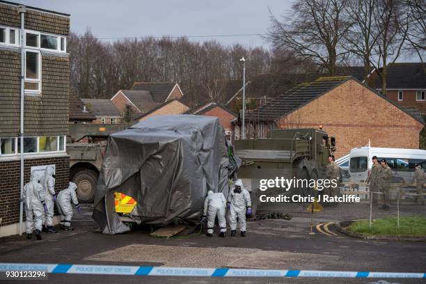 Military personnel wearing protective suits load an ambulance on to a truck as they prepare to remove it from Salisbury ambulance station as they...