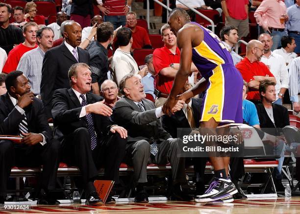 Assistant coach Elston Turner, assistant coach Jack Sikma and head coach Rick Adelman of the Houston Rockets are greeted by Ron Artest of the Los...