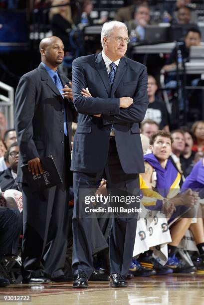 Assistant coach Brian Shaw and head coach Phil Jackson of the Los Angeles Lakers stand on the sideline during the game against the Houston Rockets on...