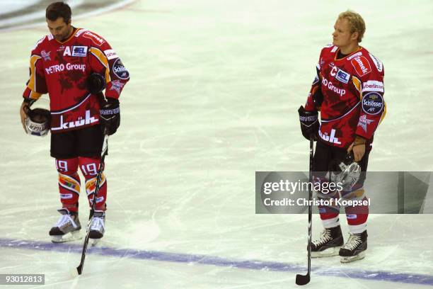 Rob Collins and Daniel Kreutzer of the Metro Stars stand up for a minute's silence after the death of footballer Robert Enke before the DEL match...