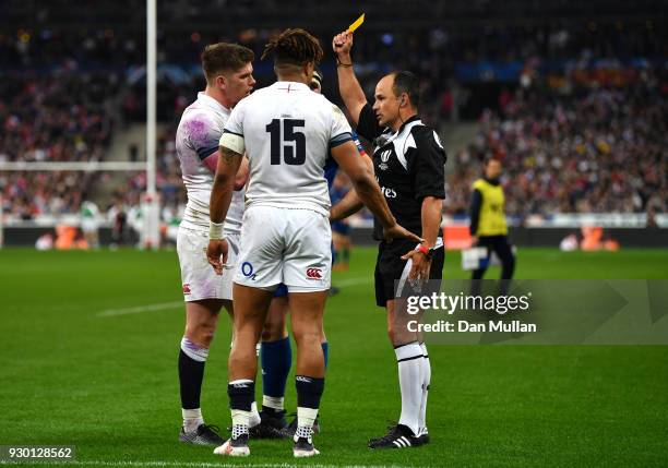 Owen Farrell of England argues with referee Jaco Peyper as he shows Anthony Watson of England a yellow card and sends him to the sin bin during the...