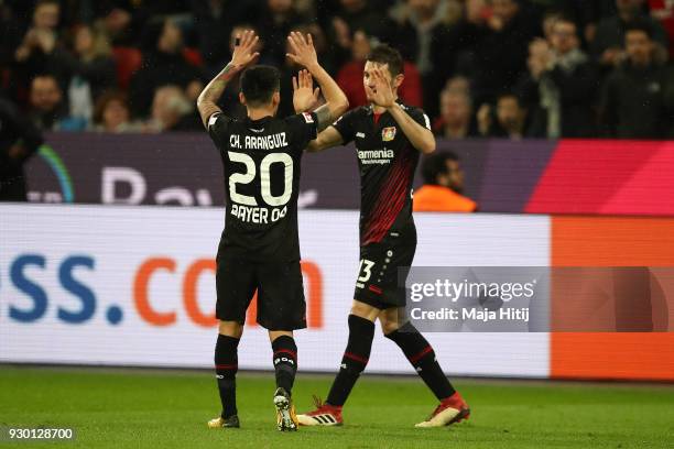 Lucas Alario of Leverkusen celebrates with Aranguiz of Bayer Leverkusen after he scored a goal to make it 1:0 during the Bundesliga match between...