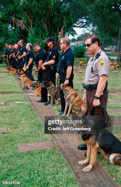 Policemen standing with German Shepherds at the Oaklawn Pet Cemetery for Humane Society Veterans Day event.