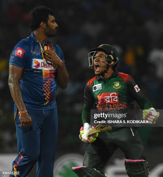 Bangladesh cricketer Mushfiqur Rahim celebrates his team's five wicket victory over Sri Lanka as Sri Lankan cricketer Thisara Perera looks on after...