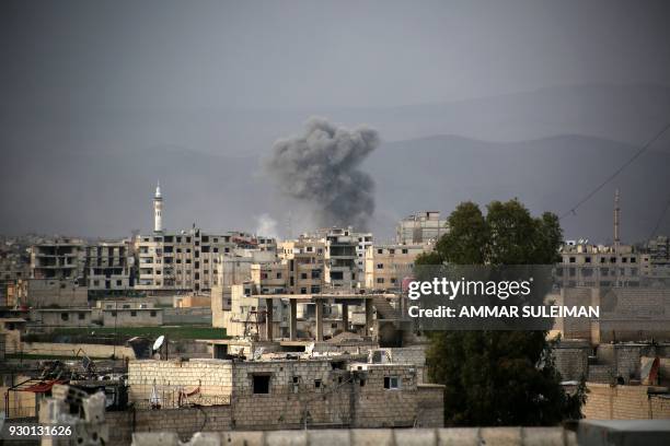 Smoke billows following Syrian government bombardment in Arbin in the rebel-held enclave of Eastern Ghouta on March 10, 2018. Syrian regime forces...