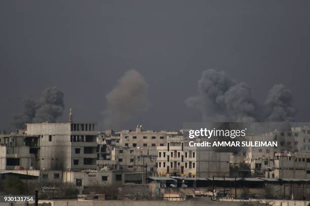 Smoke billows following Syrian government bombardment on the rebel-controlled town of Misraba, in the eastern Ghouta region on the outskirts of the...