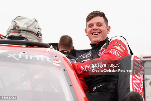 Spencer Gallagher, driver of the Kingman Chevrolet Chevrolet, climbs into his car during qualifying for the NASCAR Xfinity Series DC Solar 200 at ISM...