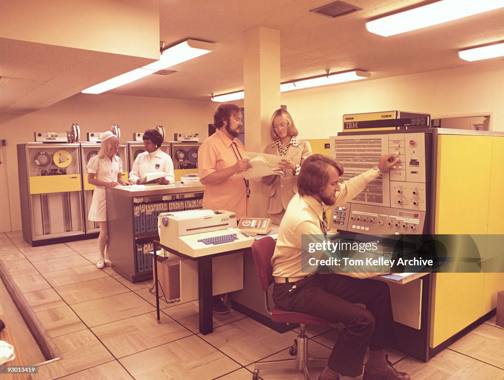 Early Office Computer View of medical workers and nurses in a computer room with early IBM ...