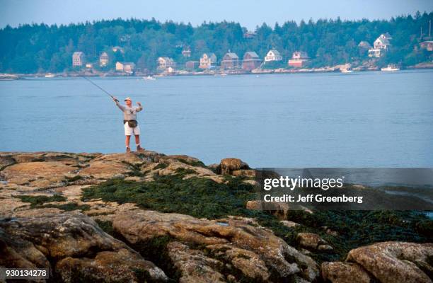 Man fishing at the mouth of Kennebec River, Maine.